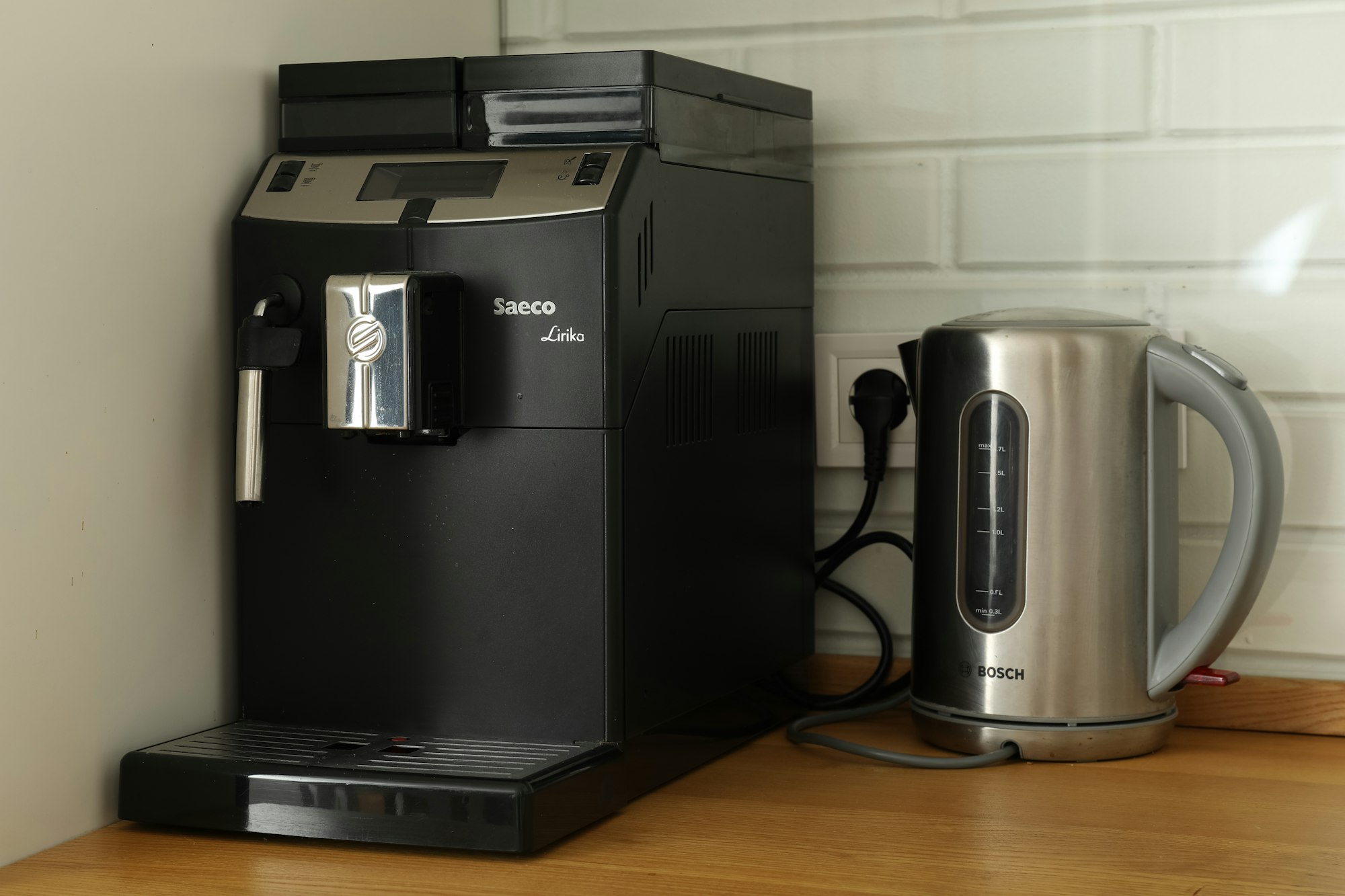 Black coffee machine and kettle on the table