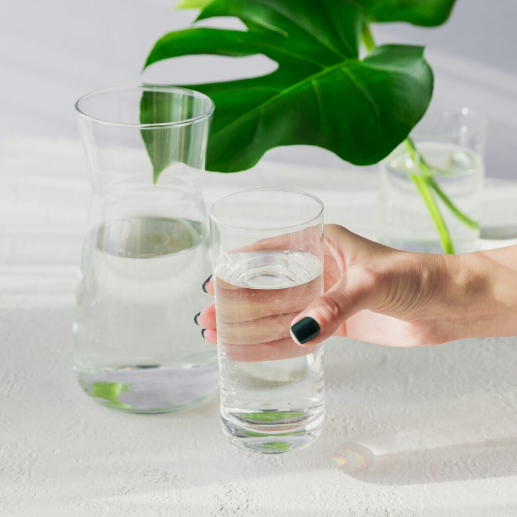 Females hand holds a glass of clean water