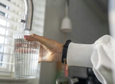 Lady filling her glass with fresh clean water